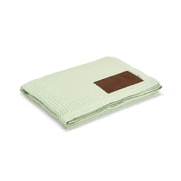 A light green waffle blanket with a brown customisable patch on one side. Features a textured design.