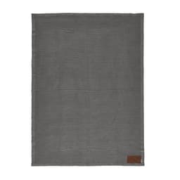 A grey blanket with a textured pattern and a brown patch featuring branding. Ideal for customization.