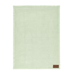 A green Giotto blanket with a textured pattern and a brown patch, featuring a branding logo.