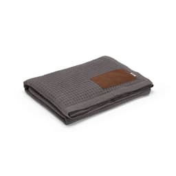 A grey blanket made of cotton with a customisable patch. It features a textured design and is folded neatly.
