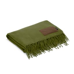 A folded green blanket featuring fringed edges and a brown customisable patch. It has a logo on one side.