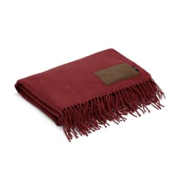A burgundy blanket with fringed edges and a brown customisable patch. It has a simple and elegant design.