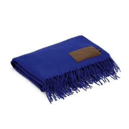 A blue blanket made from rPET, featuring fringed edges and a customisable patch.
