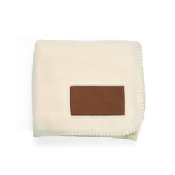A cream-coloured blanket with a brown customisable patch, featuring a stitched edge design.