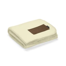 A folded cream blanket made from rPET, featuring a customisable brown patch and a small logo.