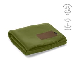 A folded green blanket made from sustainable materials, featuring a brown customizable patch.