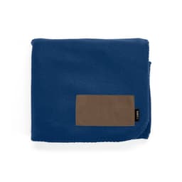 A blue blanket made from rPET material, featuring a brown customisable patch and a small logo.