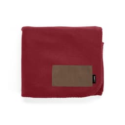 A burgundy fleece blanket with a brown customisable patch and a logo.