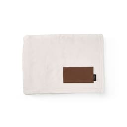 A soft white blanket with a brown customisable patch. It has a smooth texture and a subtle design.