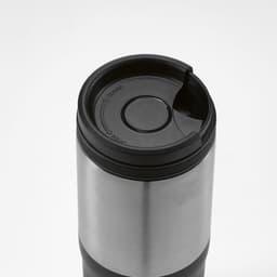 A drink bottle with a stainless steel body and an orange lid, featuring a leakproof design and a logo.