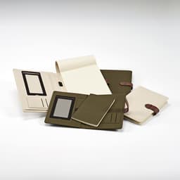 An olive green and cream folder with a notepad, elastic closures, and pockets for cards and documents.