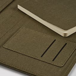An olive green A4 folder with a rCotton texture, featuring a 64-page notepad and a rPU closure.