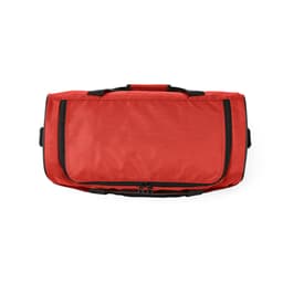 A red gym bag with black handles and zippers, featuring reflective strips for visibility. Contains a logo.