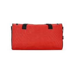 A red gym bag with black handles, featuring reflective strips and a logo. The bag is made of ripstop material.