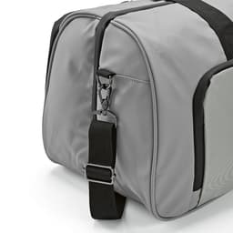 A grey gym bag with waterproof zippers and an adjustable strap, featuring a side pocket and branding.