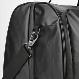 A black gym bag featuring waterproof zippers and a metal clip for adjustable straps, with a glossy finish.