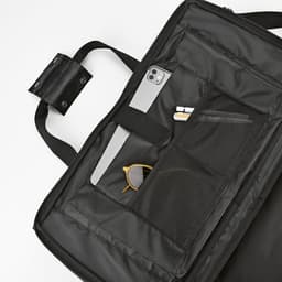A black gym bag with various compartments, including storage for a phone, sunglasses, and other small items.
