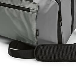 A grey gym bag with waterproof zippers and a black adjustable strap, featuring a small logo tag.