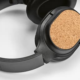 Black headphones with a cork finish on the ear cup, featuring a sleek design and adjustable headband.