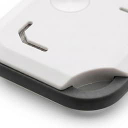 A VibeTag tracker in white and black with a smooth surface and rounded edges, featuring a sleek design.