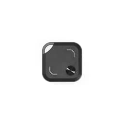 A VibeTag tracker in grey, featuring a sleek, square design with curved edges and a circular button.