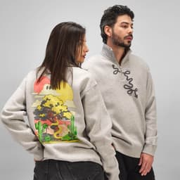 A grey quarter-zip sweatshirt featuring a graphic design with cacti and a snake on the back, alongside a person wearing it.