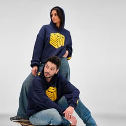 Oversized navy hooded sweatshirt made from organic cotton, rCotton, and rPET, featuring a logo.