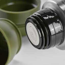 A drink bottle with a black lid and olive green cups, accompanied by a carabiner. It features a logo.