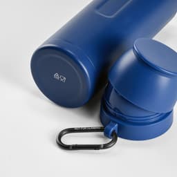 A drink bottle in navy blue with two cups and a black carabiner, featuring a logo.