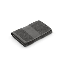 A grey cotton towel featuring textured and smooth sections, neatly folded. It has a logo on one side.
