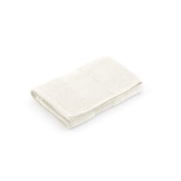 A folded cream towel made of cotton, featuring a textured surface and a branding logo.