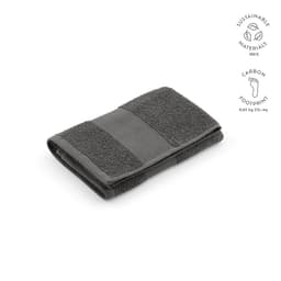 A grey cotton towel, made in Portugal, featuring terry and flat knit textures and a logo branding.
