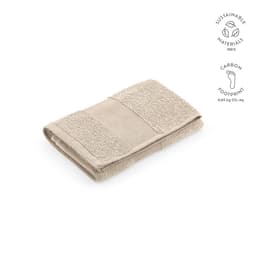 A folded beige towel with textured panels, made from 100% sustainable materials, featuring a logo.