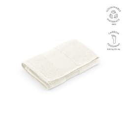 A folded cream towel made from 100% sustainable materials, featuring a textured design and a logo.