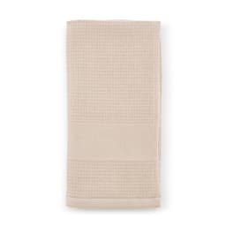 A cotton towel in a soft beige hue, featuring a textured design and subtle branding. Made in Portugal, 500 gsm.
