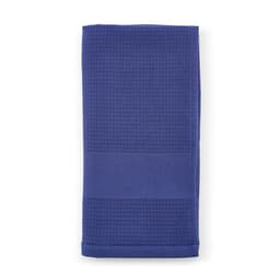 A folded cotton towel in a deep blue shade, featuring a textured pattern. It has a branding logo.