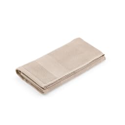 A folded beige cotton towel with a textured pattern, featuring a branding logo.