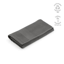 A folded grey towel with a textured design, showcasing sustainable materials and a logo.