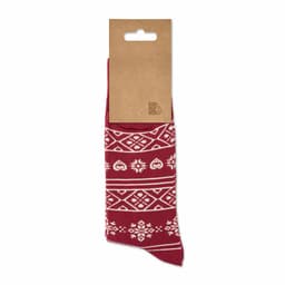 A pair of red socks with white patterns, displayed on a cardboard backing. The socks feature decorative designs.