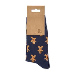 A pair of navy socks featuring a gingerbread man pattern, packaged with a cardboard tag. The socks are playful and festive.