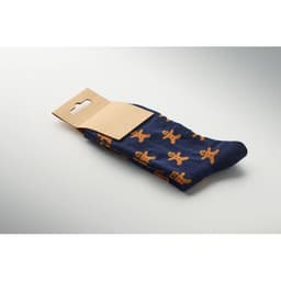 A pair of navy socks with an orange gingerbread man pattern, packaged with a cardboard header.