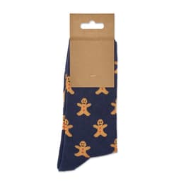 A pair of navy socks decorated with gingerbread man patterns, hanging on a cardboard tag.