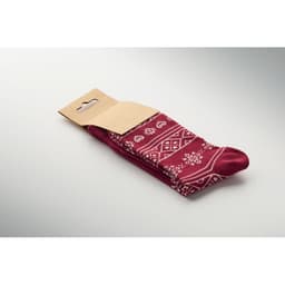 A pair of burgundy socks with a decorative white pattern, packaged with a cardboard header.