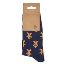 A pair of blue socks featuring a gingerbread man pattern, packaged with a cardboard header and a hanging hook.