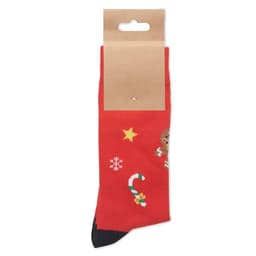 A pair of red festive socks featuring patterns of a reindeer, snowflakes, and candy canes, displayed with a cardboard tag.