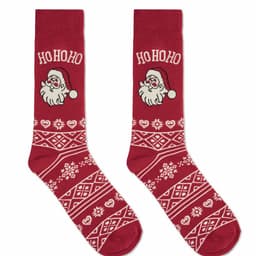 A pair of red socks featuring a Santa design with white patterns and a festive motif.