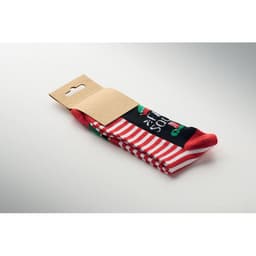 A pair of red and black socks featuring Christmas-themed designs, packaged with a plain cardboard backing.