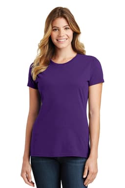 A woman wearing a purple fitted T-shirt, smiling while standing against a neutral background. The shirt has a logo.