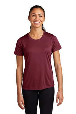 A woman wearing a maroon Sport-Tek Ladies PosiCharge Competitor Tee, with a simple design and a logo.