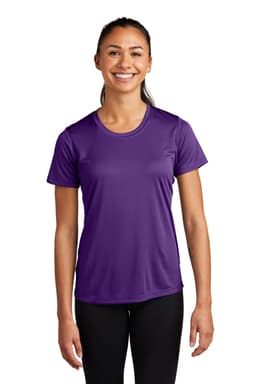 A smiling woman wearing a short-sleeve purple athletic t-shirt. The tee features a logo.